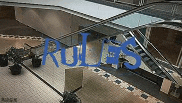 an escalator in a mall with the word rules in blue