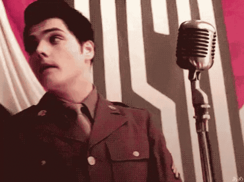 a man in a military uniform singing into a microphone