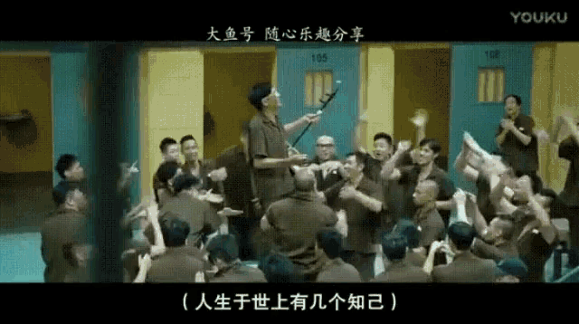 a group of people are gathered in a room with the number 155 on the wall behind them