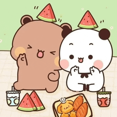 a couple of bears are sitting at a table eating watermelon slices .