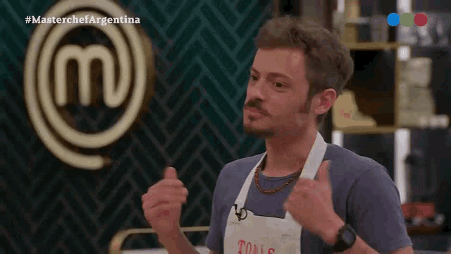 a man wearing an apron with the word tono on it stands in front of a masterchef logo