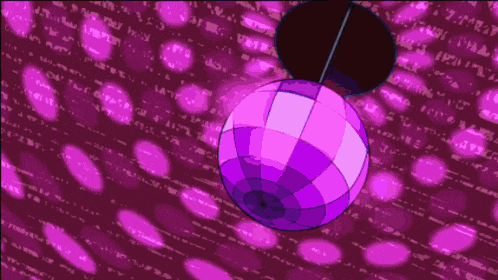 a purple disco ball is hanging from a string in front of a pink background