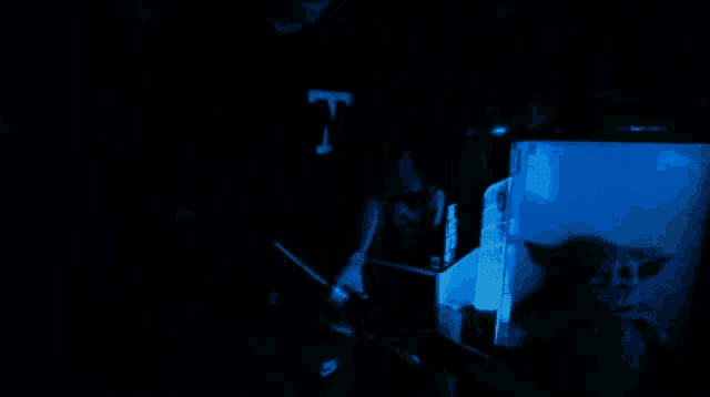 a person is holding a light in a dark room