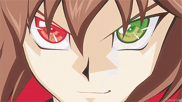 a close up of a cartoon character 's face with red and green eyes