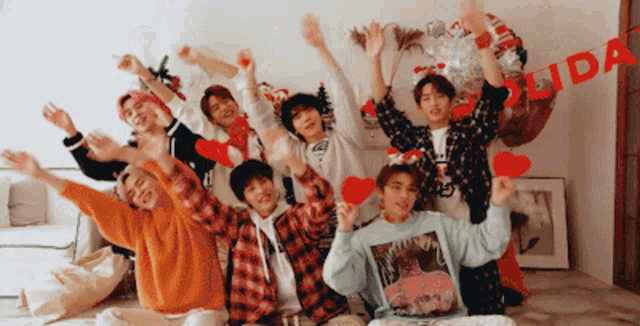 a group of young men are posing for a picture with their arms in the air and a sign that says lida