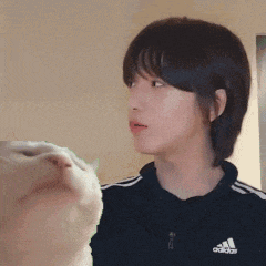 a close up of a woman 's face with a cat behind her