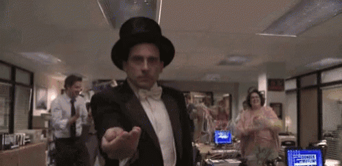 a man in a top hat and bow tie is standing in an office