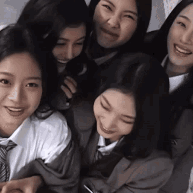 a group of young women are posing for a picture together