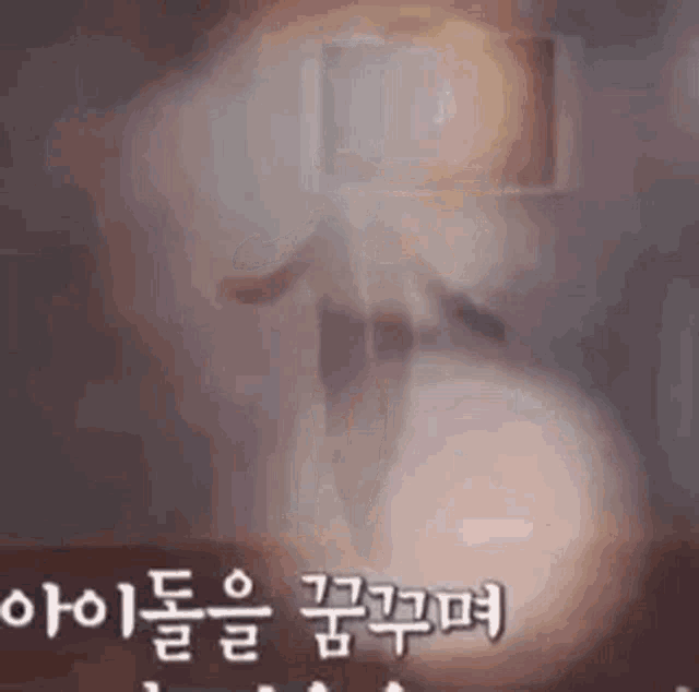 a blurred image of a person standing in a dark room with chinese writing .