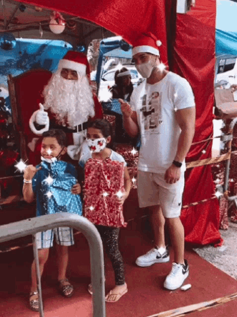 a man wearing a mask is standing next to a man dressed as santa