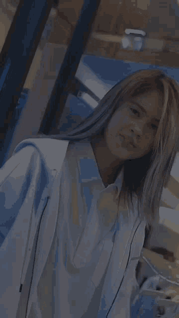a woman wearing a white jacket and a white polo shirt