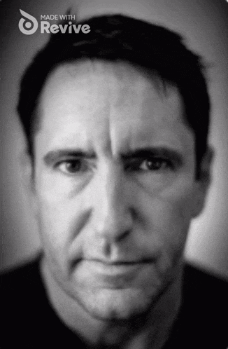 a black and white photo of a man with the words made with revive above his head