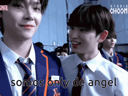 two boys in suits and ties are standing next to each other with the words somos only de angel above them