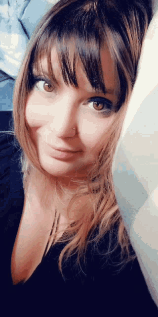a close up of a woman 's face with a nose ring