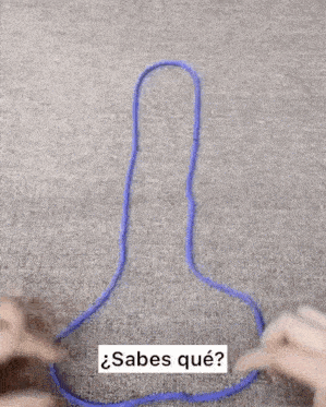 a person is holding a purple rope in their hands and making a penis shape .