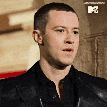 a close up of a man 's face with a mtv logo
