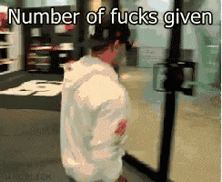 a man in a white shirt is standing in front of a glass door with the words number of fucks given below him