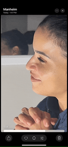 a phone screen shows a woman 's face and says manheim