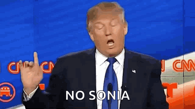 a man in a suit and tie is giving the middle finger and says no sonia