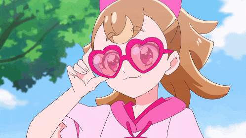 a girl wearing pink heart shaped sunglasses looks at something