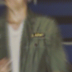 a blurred image of a man in a suit and tie .