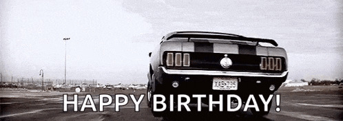 a black and white photo of a mustang driving down a road with the words `` happy birthday ! ''