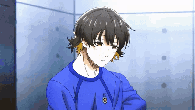 a cartoon character wearing a blue shirt with the letter k on the front