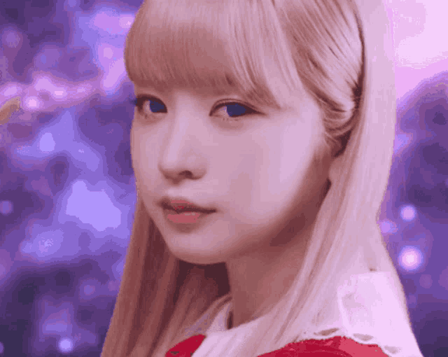 a close up of a girl 's face with blonde hair