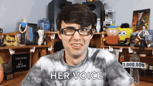 a man wearing glasses and a tie dye shirt with the words her voice on it