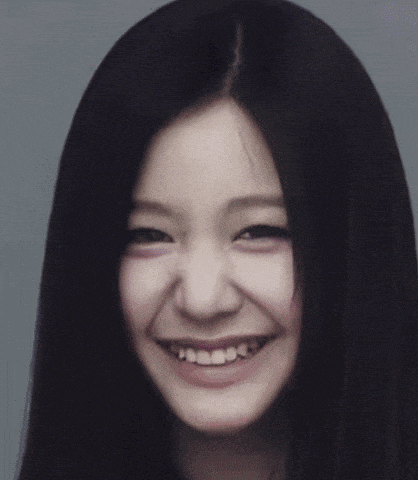 a close up of a woman 's face with a blurry background .