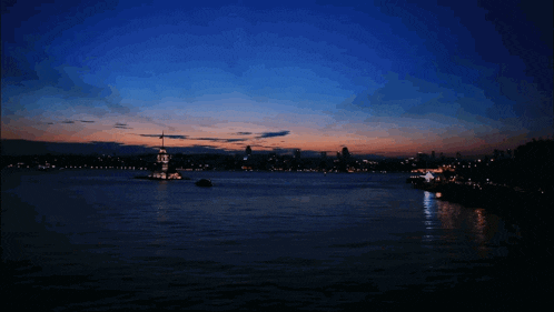 a large body of water with a lighthouse in the middle