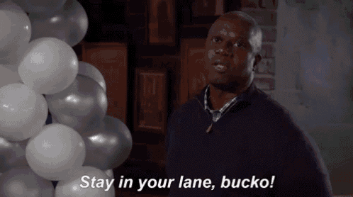 a man is standing in front of a bunch of balloons and saying stay in your lane bucko !