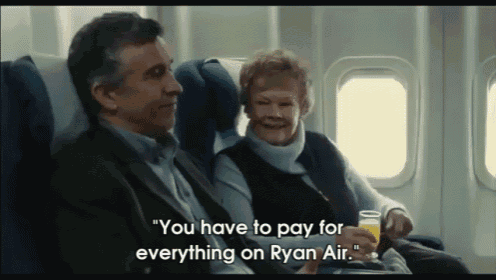 a man and a woman are sitting on an airplane and the woman says " you have to pay for everything on ryan air "