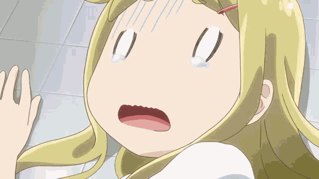 a cartoon girl with blonde hair is making a funny face