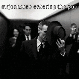 a man in a suit covering his face with a hat with the words mrjonesceo entering the pub above him
