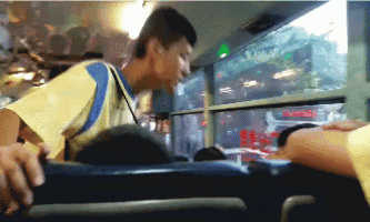 a pixelated image of a man sitting on a bus with the word emergency on the window