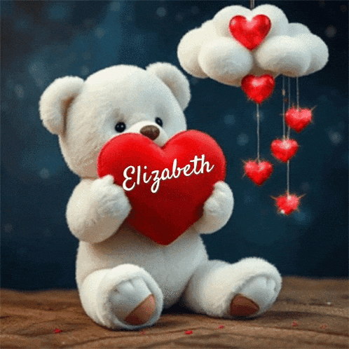 a white teddy bear holding a red heart with the name elizabeth on it