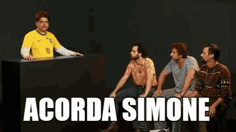 a group of men are sitting around a table with the words acorda simone on the bottom