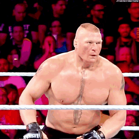 a shirtless wrestler in a boxing ring with the next big thing written on the bottom right