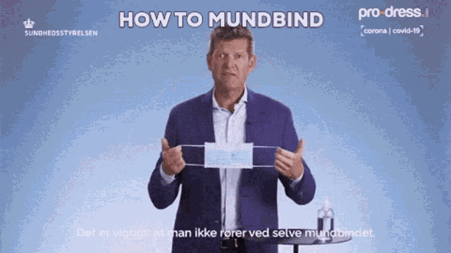 a man in a purple suit is holding a mask with the words how to mundbind at the top