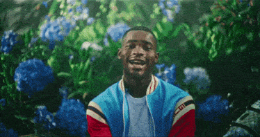 a man in a blue and red jacket with the letter g on it