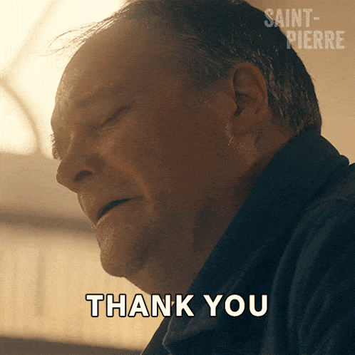 a man with his eyes closed and a thank you sign