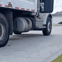 a white truck is parked on a concrete driveway