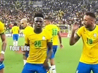 a group of soccer players are dancing on a field with the words `` your life '' written above them .