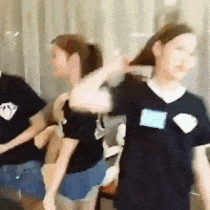 a group of people are standing next to each other in a room .