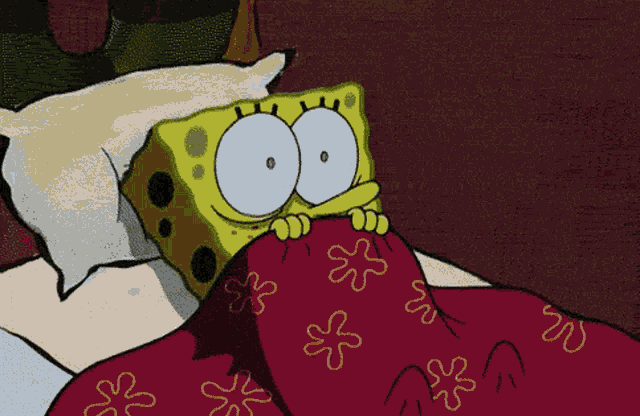 a cartoon of spongebob laying in bed under a blanket