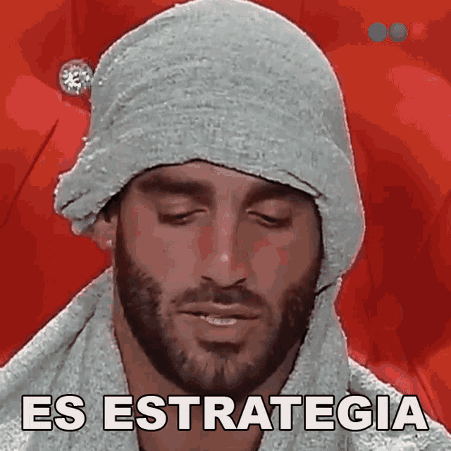 a man with a beard wearing a towel around his head and the words es estrategia written on the bottom