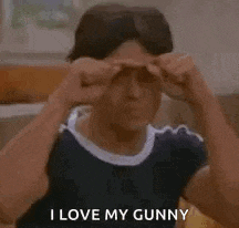a young man is adjusting his sunglasses and says `` i love my gunny '' .