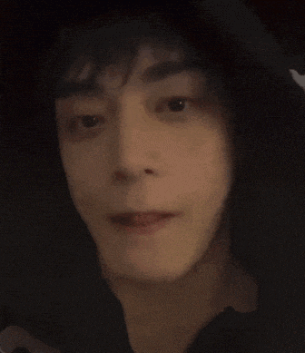 a close up of a person 's face with a hoodie on