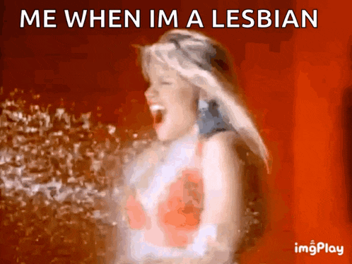 a woman is spraying water with the words me when im a lesbian behind her